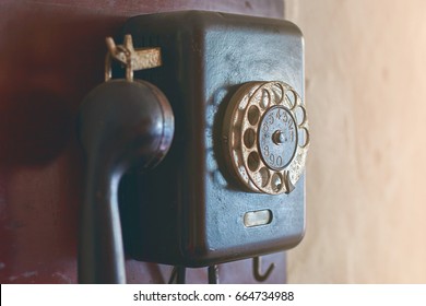 Retro Rotary Dial Phone Hanging On The Wall