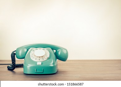 Retro rotary telephone on wood table - Shutterstock ID 151866587