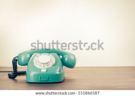 Retro rotary telephone on wood table