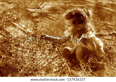 retro sepia photo, little baby girl studying touching look yellow flower(Chamaecytisu s ruthenicus) spring Stock photo © 