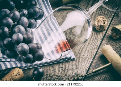 Retro setting with empty wine glass and grapes - Powered by Shutterstock