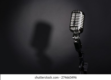 Retro silver microphone on gray background