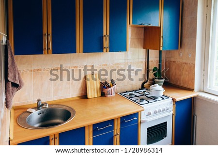 Retro simple kitchen interior design with ugly messy cabinets  in need of remodel.