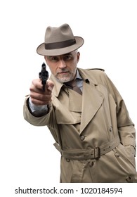 Retro Spy Agent Pointing A Gun, He Is Wearing A Trench Coat And A Hat