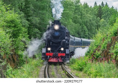 Retro steam train approaches to the platform. - Shutterstock ID 2209279177