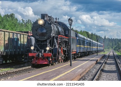 Retro Steam Train Approaches To The Station Platform.