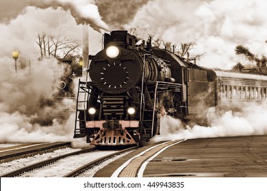 Retro steam train departs from the station. - Powered by Shutterstock