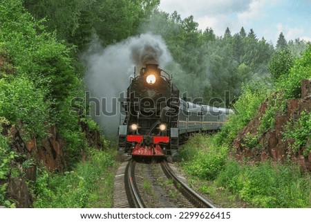 Retro steam train moves at summer morning time.