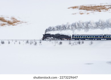 Retro steam train moves at winter day time. - Powered by Shutterstock