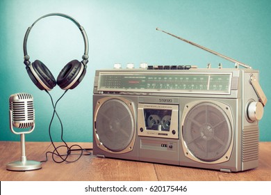 Retro Stereo Portable Radio With Cassette Tape Recorder, Microphone And Headphones Conceptual Still Life. Old Style Filtered Photo