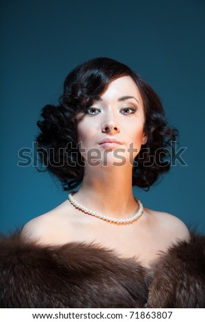 Retro style color portrait of a woman with stylish hairstyle and fashionable clothes