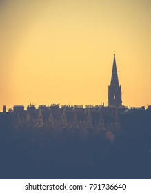 Retro Style Image Of A Row Of Edinburgh Tenement Apartments And Church Spire At Sunset