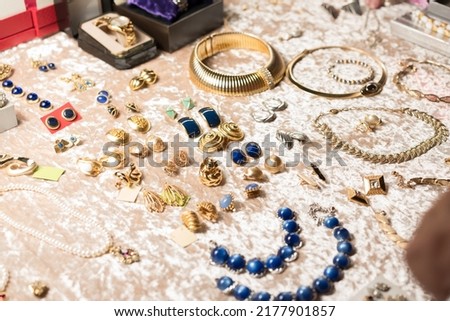Retro style jewelry, antiques at flea market or garage sale - vintage jewelry, retro earrings, necklaces and other vintage things. Collectibles memorabilia concept. Selective focus