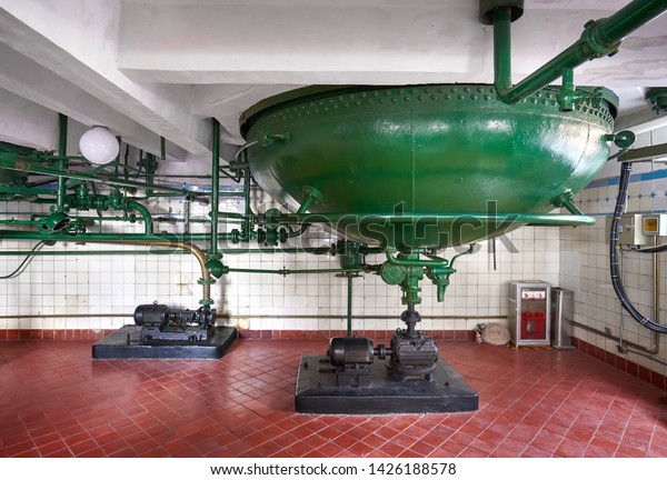 Retro style machine for beer distillery in green\
painted color.