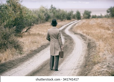Retro Style Man On The Country Road, View From Back
