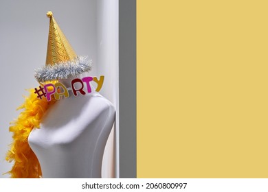 retro style mannequin with party hat and decoration yellow feather