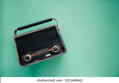 Retro style old  boombox radio from 1950s, 1960s  on green pastel paper background and Vintage tone instagram style filter photo