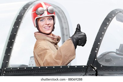 Retro Style Picture Of A Pilot In Cockpit Of A Vintage Plane. Close Up With Shallow DOF.