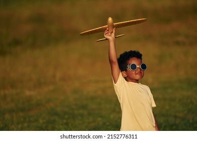 Retro Style Pilot Sunglasses. African American Kid Have Fun In The Field At Summer Daytime.