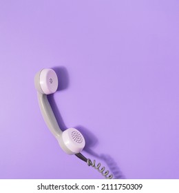 Retro style visual with phone receiver on pastel purple background. Minimal flat lay. Communication scene with copy space. - Shutterstock ID 2111750309