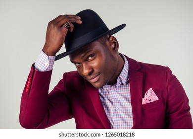 Retro Style Well Dressed African American Business Man Model In Red Suit And Black Hat In Studio On White Background