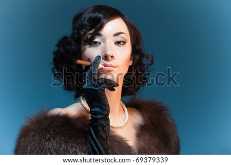 Retro style woman smoking cigar and wearing fur, movies star look