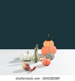 Retro styled conceptual still life arrangement with pumpkins and hard shadows. Halloween holiday theme creative concept. Autumn colors. Modern aesthetic. Copy space.
