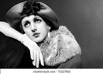 Retro Styled Fashion Portrait Of A Young Woman In Hat. Clothing And Make-up In Vintage Style