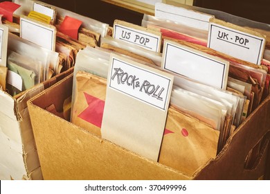 Retro styled image of boxes with vinyl turntable records on a flee market