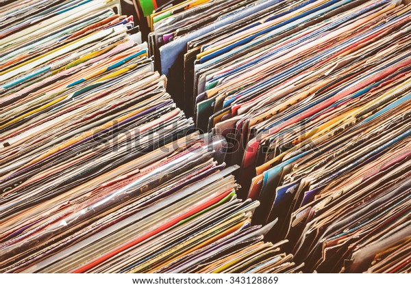 Retro styled image of boxes with vinyl turntable\
records on a flee market