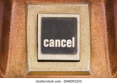 Retro styled image of a cancel push button on a vintage arcade game machine