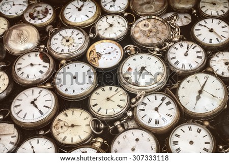 Retro styled image of old scratched and run down pocket watches