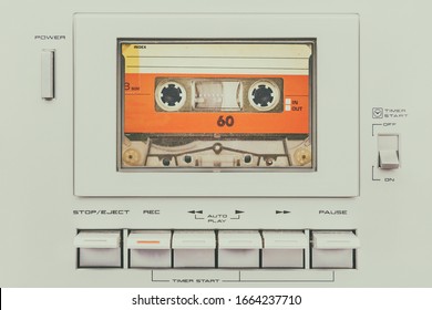 Retro styled image of a vintage silver audio cassette player with buttons