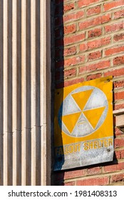 Retro Styled Nuclear Fallout Shelter Sign On A Red Brick Wall.