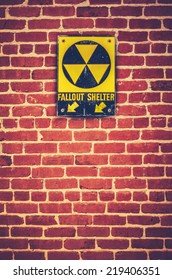 Retro Styled Nuclear Fallout Shelter Sign On A Red Brick Wall