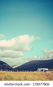 Retro Styled Photo Of A Campervan Or RV In The British Countryside