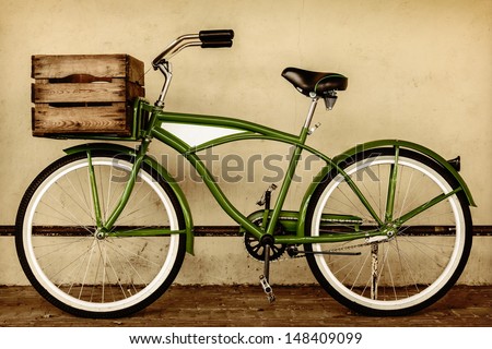 Retro styled sepia image of a vintage beach cruiser bicycle with wooden crate
