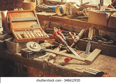 Retro Stylized Old Tools On Wooden Table In A Joinery.