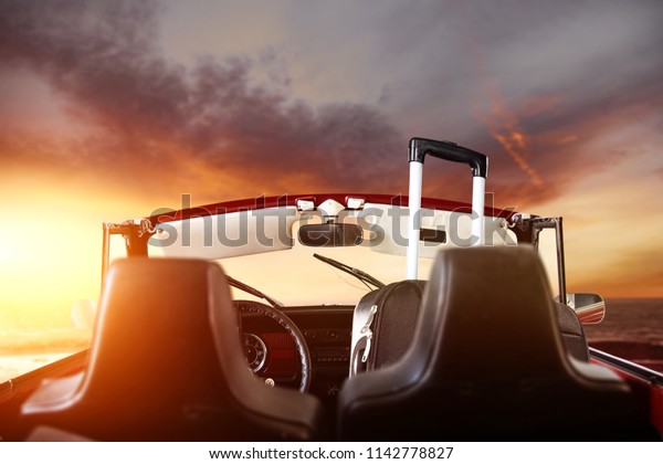 Retro summer car with\
suitcase and golden sunset time of mood color. Free space for your\
decoration. 