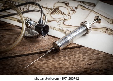 Retro syringe on a wooden table. Shallow depth of field.