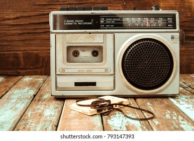 Retro technology of radio cassette recorder music with retro tape cassette on wood table. Vintage color effect styles.