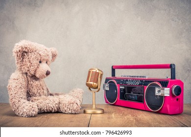 Retro Teddy Bear Toy, Classic Golden Mic And Old Outdated Cassette Radio Recorder From 80s Front Concrete Wall Background. Music Recording Concept. Vintage Style Filtered Photo