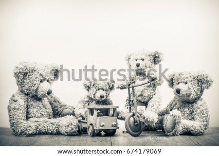 Retro Teddy Bear toys family: parents with kids on vehicles. Parenthood concept. Vintage old style sepia photo