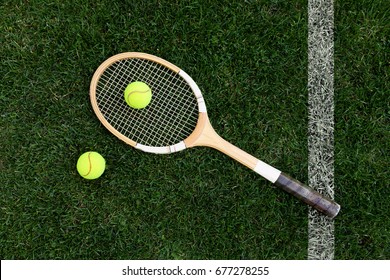 retro tennis racket on natural grass with balls. top view - Powered by Shutterstock