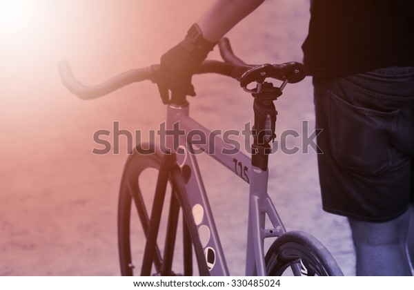 retro tone of bicycle\
,Silhouette of Retro bicycle in sunlight field at sunset, riding in\
the city