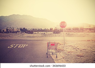 Retro Toned Empty Shopping Trolley Left On Street At Sunset, Palm Springs, USA.