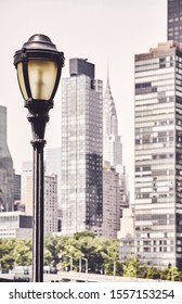 Retro Toned Picture Of A Street Lamp With New York City Blurred Skyline In Background, USA.