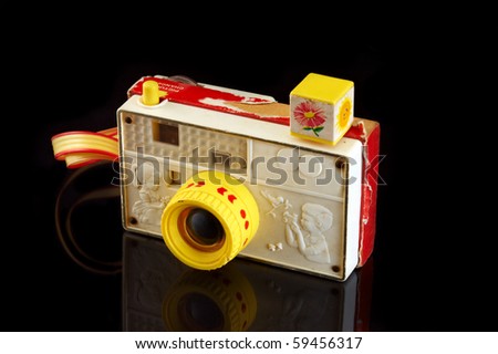 Retro toy camera on black background