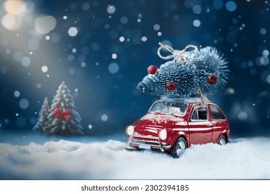 Retro toy car carrying christmas tree on roof in snowy winter forest. Christmas night background. Holidays card - Powered by Shutterstock