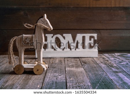 retro toy children's wooden horse on wheels on a dark wooden background